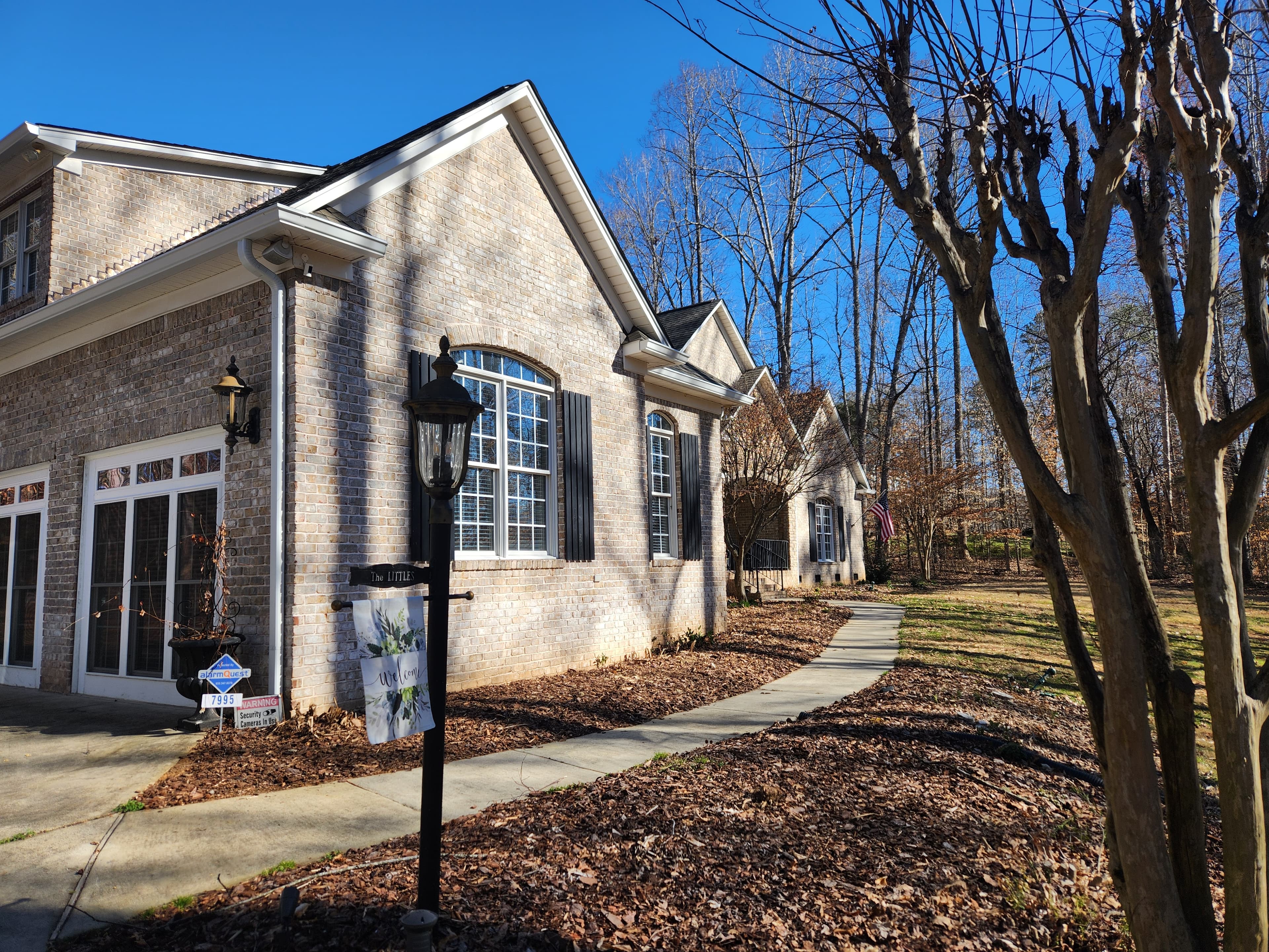 Tan brick home with seamless gutters along full roofline